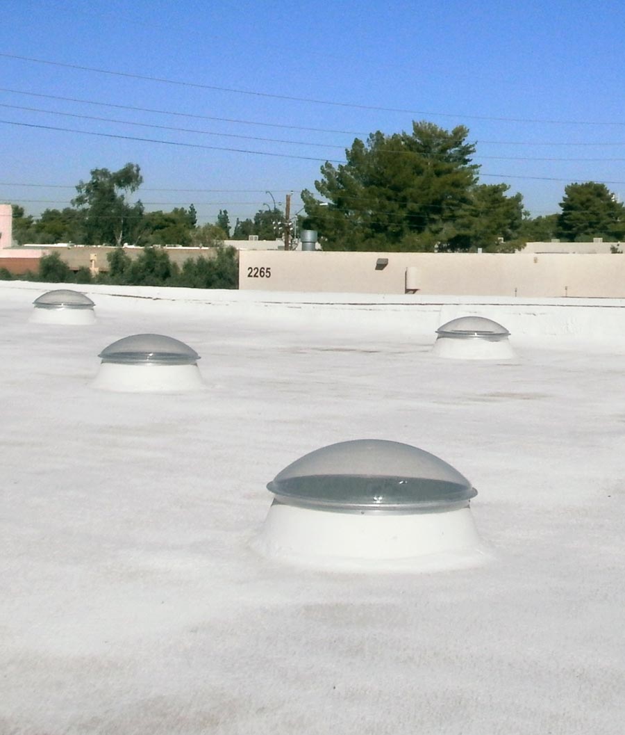 Several Natural Light flat roof tubular skylights installed on foam roof